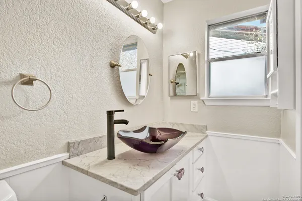 a bathroom with a sink and a mirror