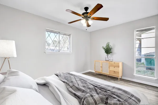 a bedroom with a large bed and a window