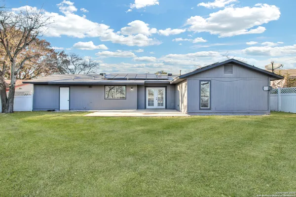 a view of a house with a backyard