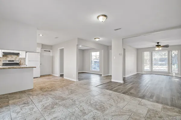 a view of a kitchen with a sink and cabinets