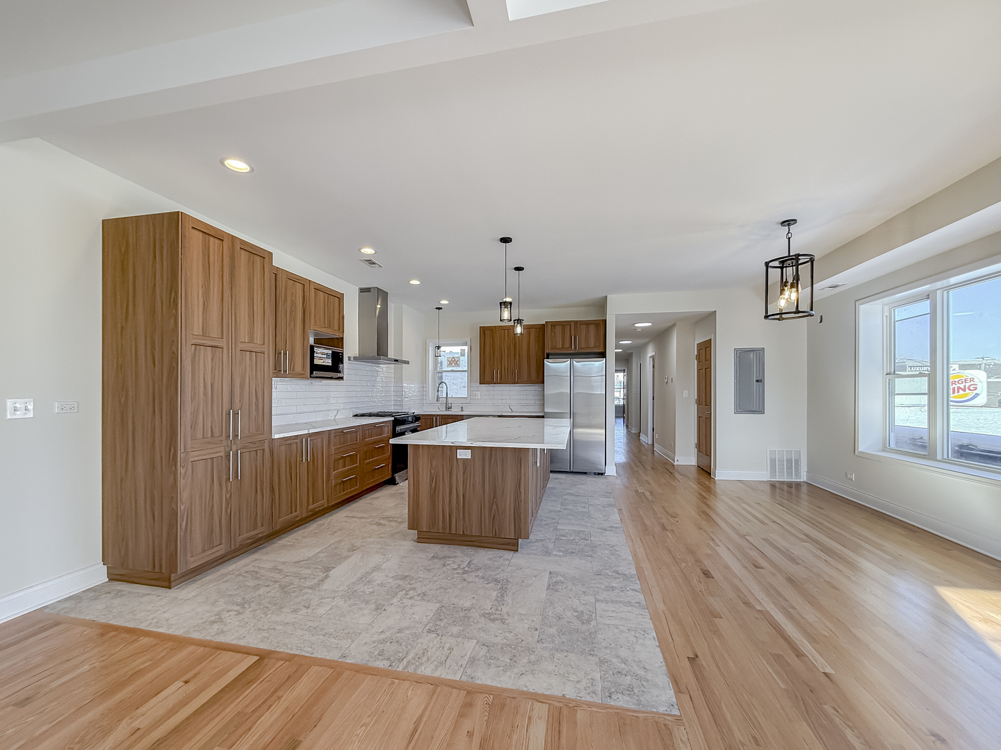 6411 West Irving Park Road, Unit 2 Chicago, IL 60634 - Photo 3 of 21 a kitchen with a wooden floor and cabinets