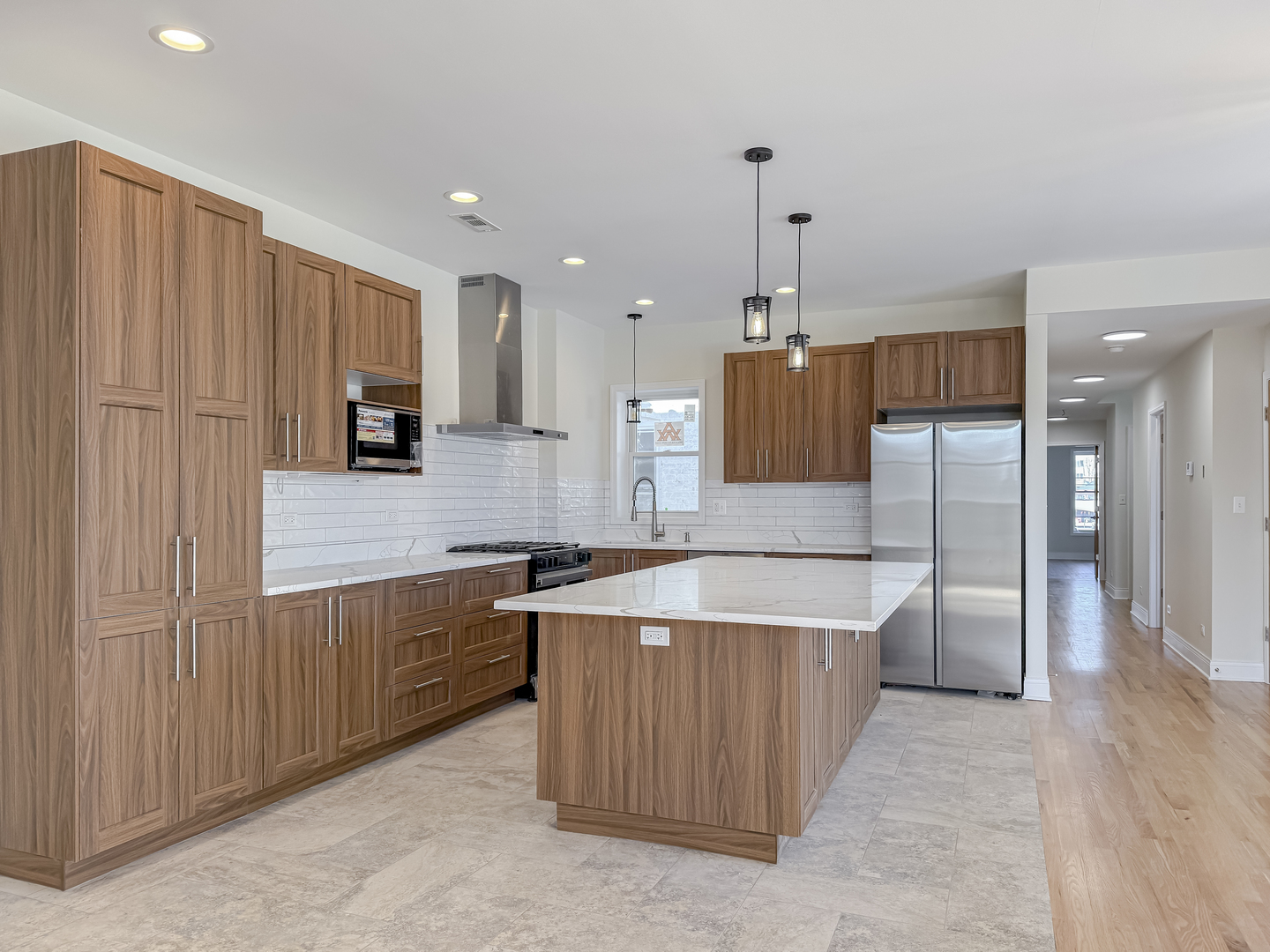 6411 West Irving Park Road, Unit 2 Chicago, IL 60634 - Photo 4 of 21 a kitchen with stainless steel appliances granite countertop a refrigerator a sink and a stove
