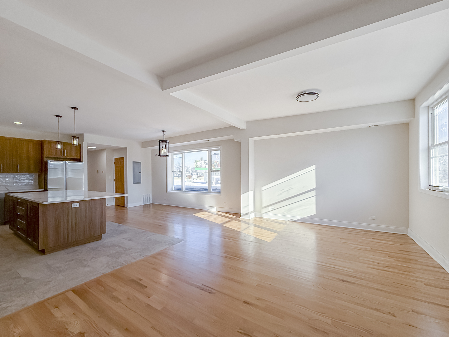 6411 West Irving Park Road, Unit 2 Chicago, IL 60634 - Photo 7 of 21 an empty room with wooden floor and windows