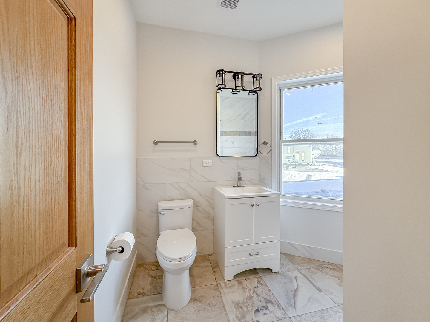 6411 West Irving Park Road, Unit 2 Chicago, IL 60634 - Photo 10 of 21 a bathroom with a toilet sink and a mirror
