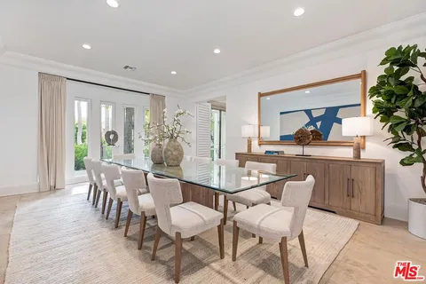 a view of a dining room with furniture and a potted plant