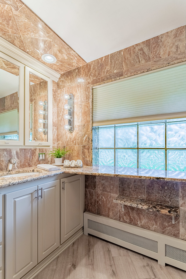 711 Greenview Road Itasca, IL 60143 - Photo 13 of 36 a bathroom with a sink and a window