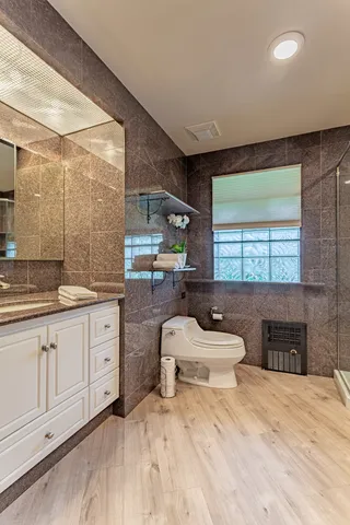 a spacious bathroom with a double vanity sink a mirror and a bathtub