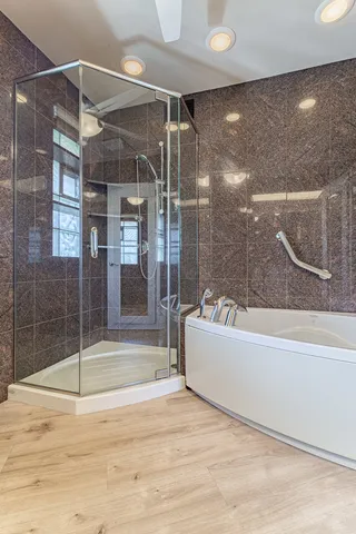 a bathroom with a bathtub and a shower