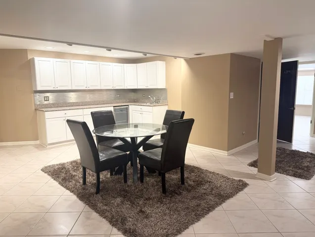 a view of a dining room with furniture and a window