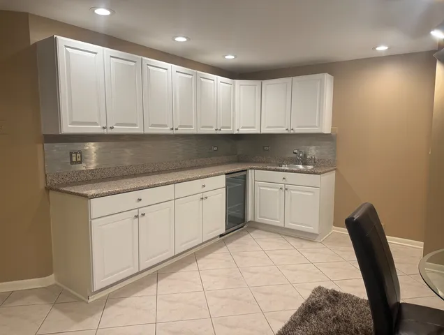 a kitchen with white cabinets