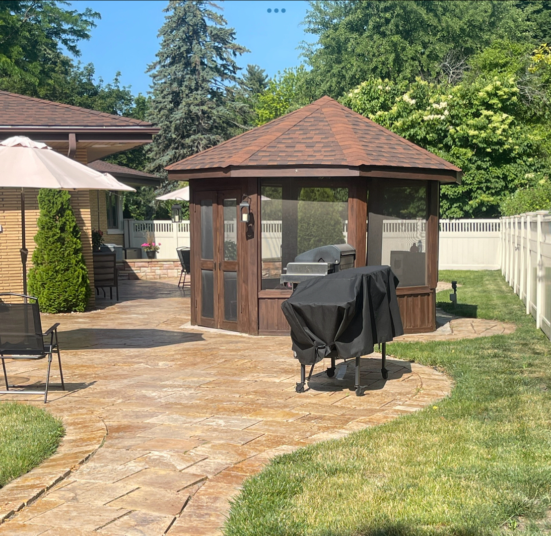 711 Greenview Road Itasca, IL 60143 - Photo 29 of 36 a view of a chair and table in the backyard of the house