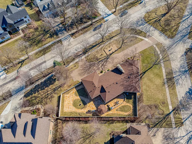 an aerial view of a backyard with table and chairs