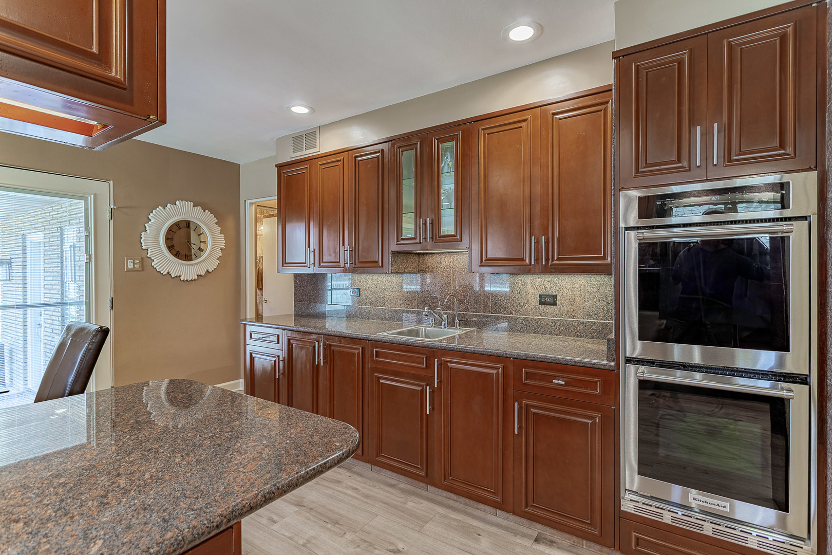 711 Greenview Road Itasca, IL 60143 - Photo 8 of 36 a kitchen with granite countertop wooden cabinets and stainless steel appliances
