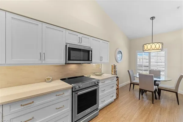 a kitchen with a sink cabinets and window