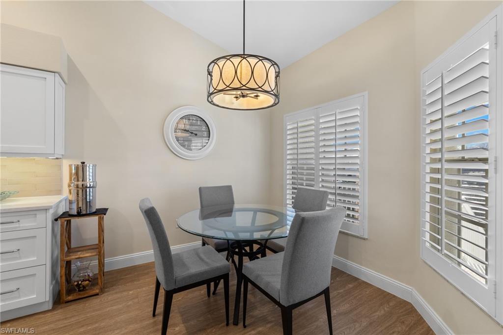 2215 Chesterbrook Court, Unit 2 Naples, FL 34109 - Photo 12 of 38 a view of a dining room with furniture window and wooden floor