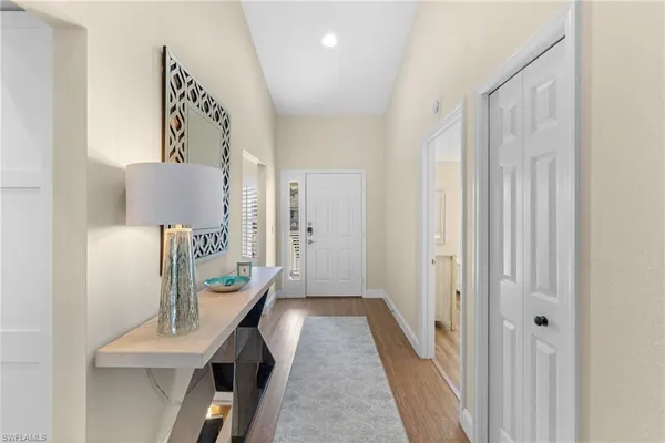 a view of a hallway to a livingroom with furniture