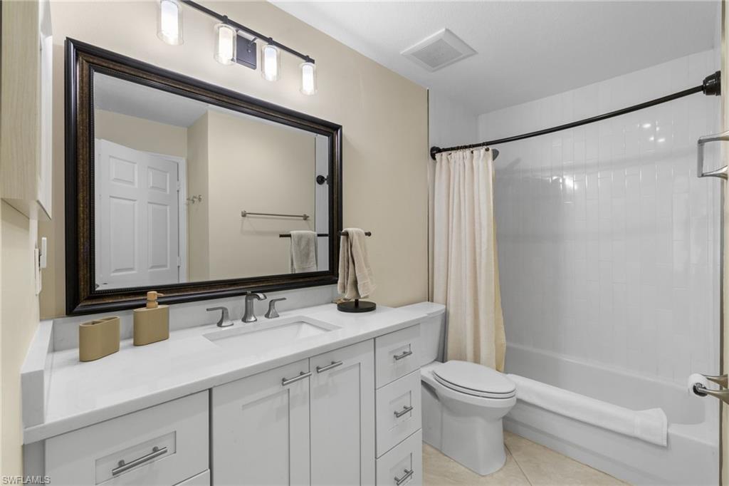 2215 Chesterbrook Court, Unit 2 Naples, FL 34109 - Photo 23 of 38 a bathroom with a sink a toilet a mirror and shower