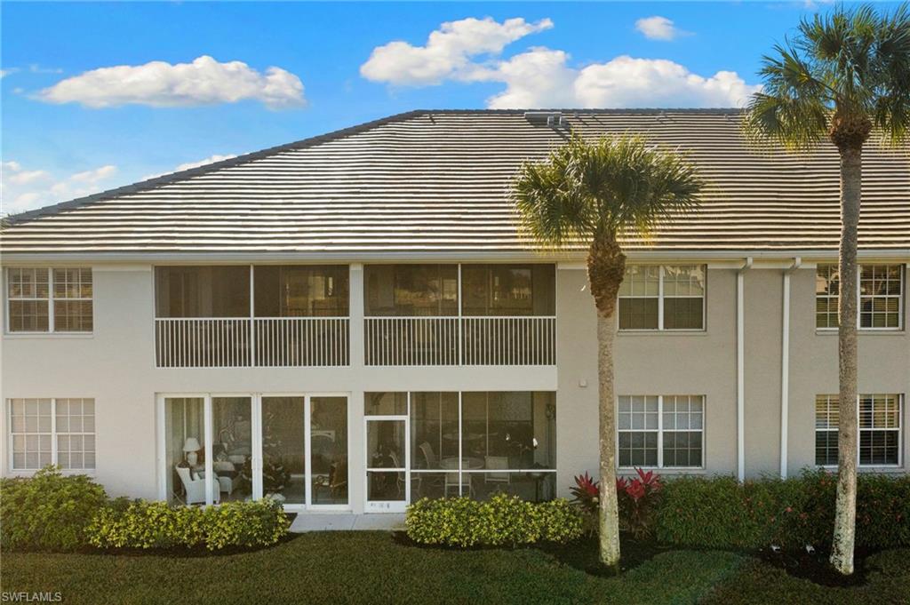 2215 Chesterbrook Court, Unit 2 Naples, FL 34109 - Photo 26 of 38 a view of a house with a yard