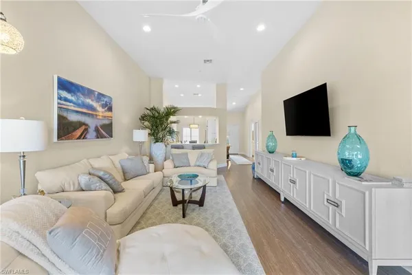 a living room with furniture a flat screen tv and a flat screen tv