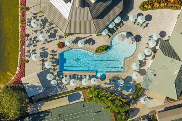 an aerial view of a wooden table and chairs