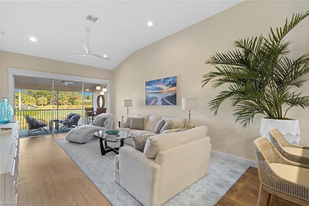 2215 Chesterbrook Court, Unit 2 Naples, FL 34109 - Photo 5 of 38 a living room with furniture large windows and wooden floor