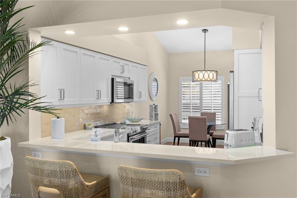 2215 Chesterbrook Court, Unit 2 Naples, FL 34109 - Photo 7 of 38 a dining room with furniture and window