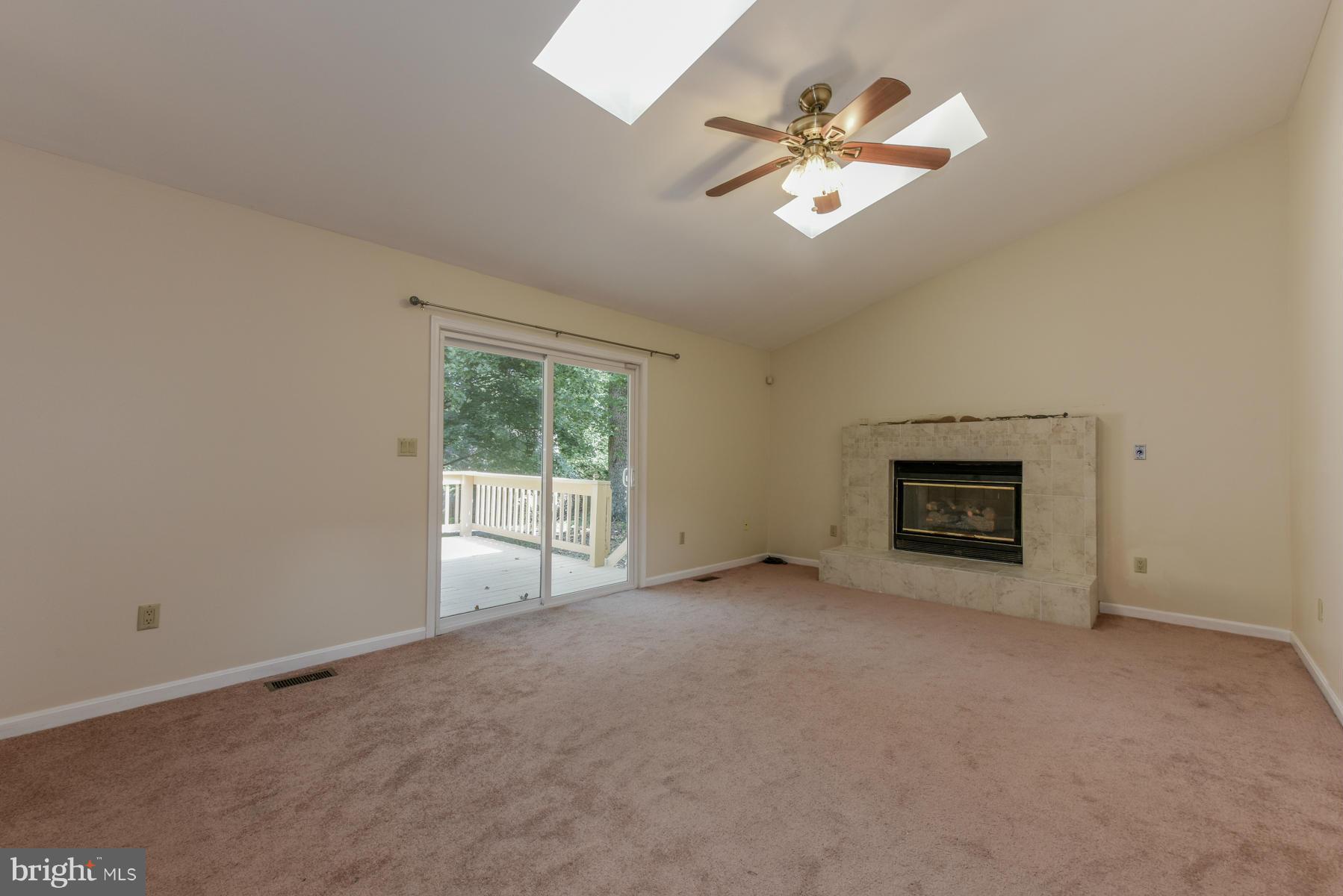 10541 Patuxent Ridge Way Laurel, MD 20723 - Photo 12 of 28 an empty room with windows and ceiling fan