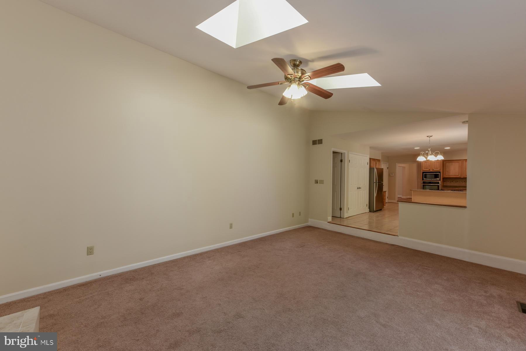 10541 Patuxent Ridge Way Laurel, MD 20723 - Photo 14 of 28 an empty room with a ceiling fan and a window