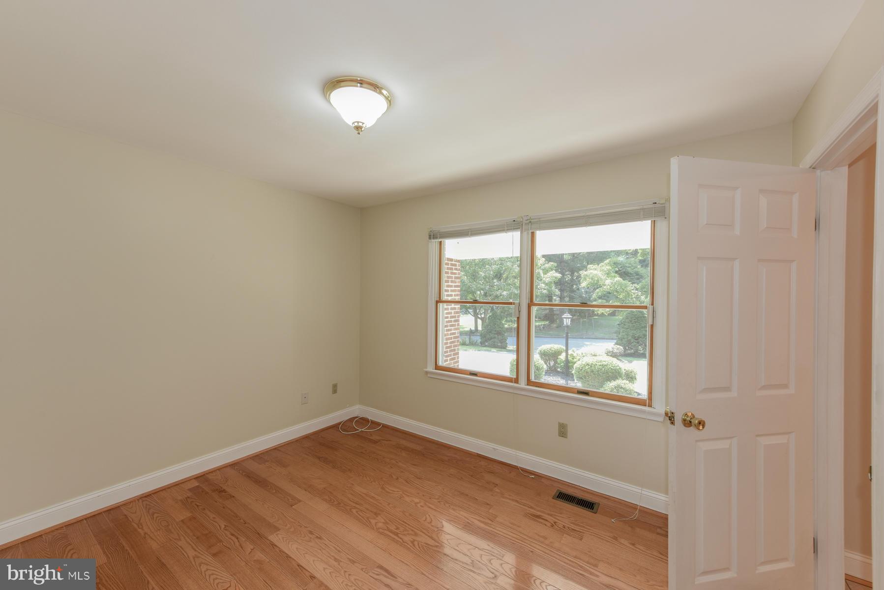 10541 Patuxent Ridge Way Laurel, MD 20723 - Photo 15 of 28 wooden floor in an empty room with a window