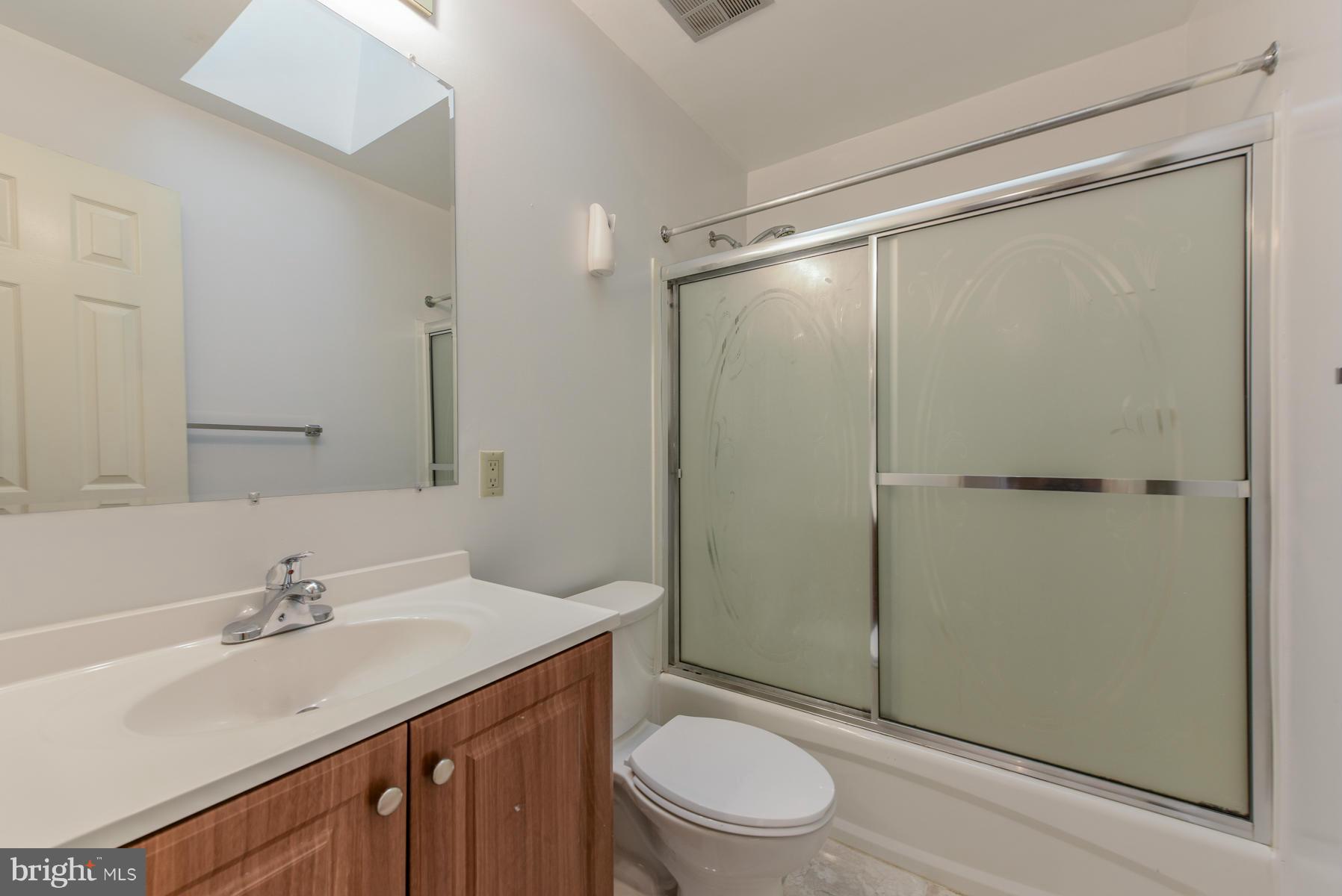 10541 Patuxent Ridge Way Laurel, MD 20723 - Photo 23 of 28 a bathroom with a sink a mirror a toilet and shower