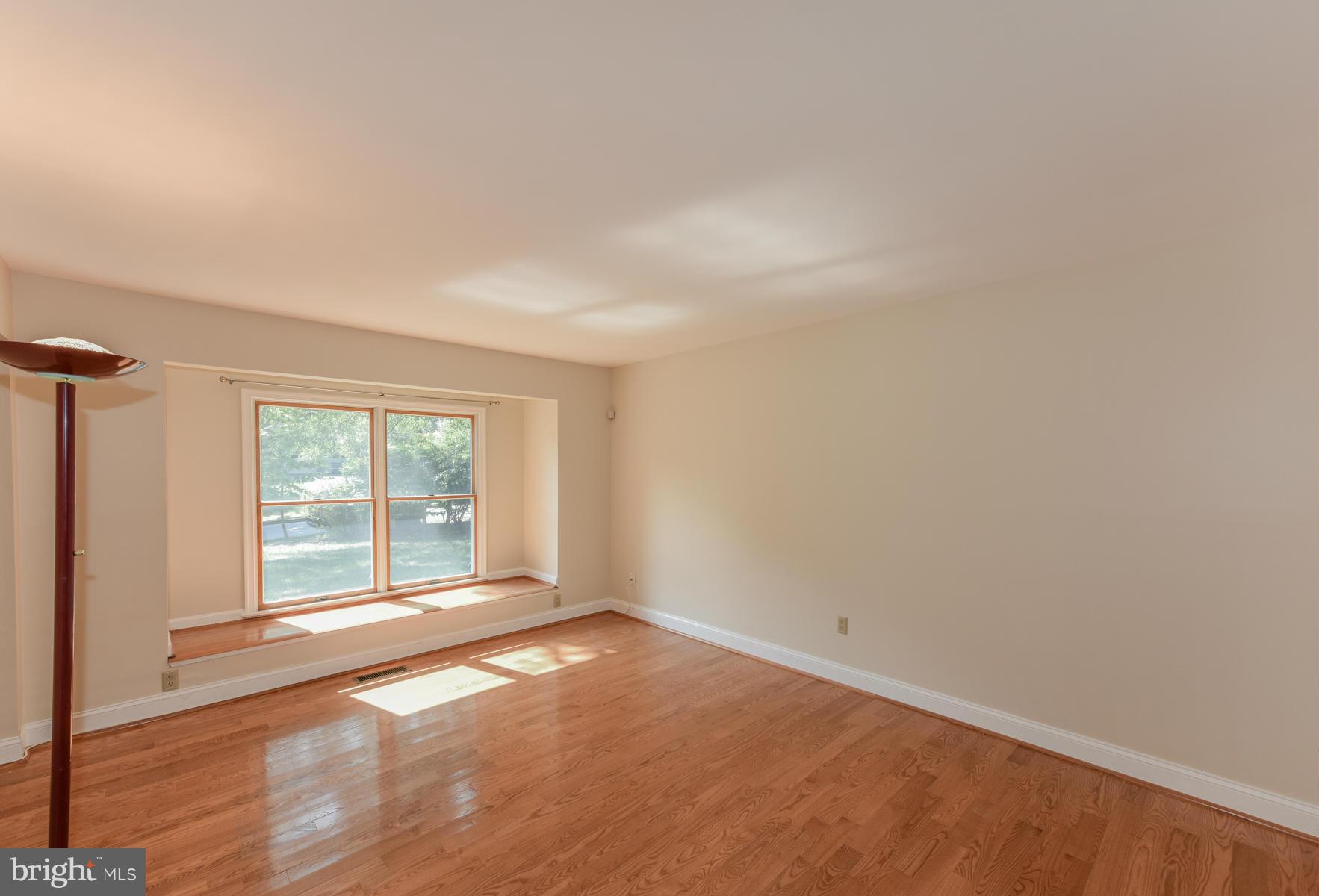 10541 Patuxent Ridge Way Laurel, MD 20723 - Photo 4 of 28 an empty room with wooden floor and windows