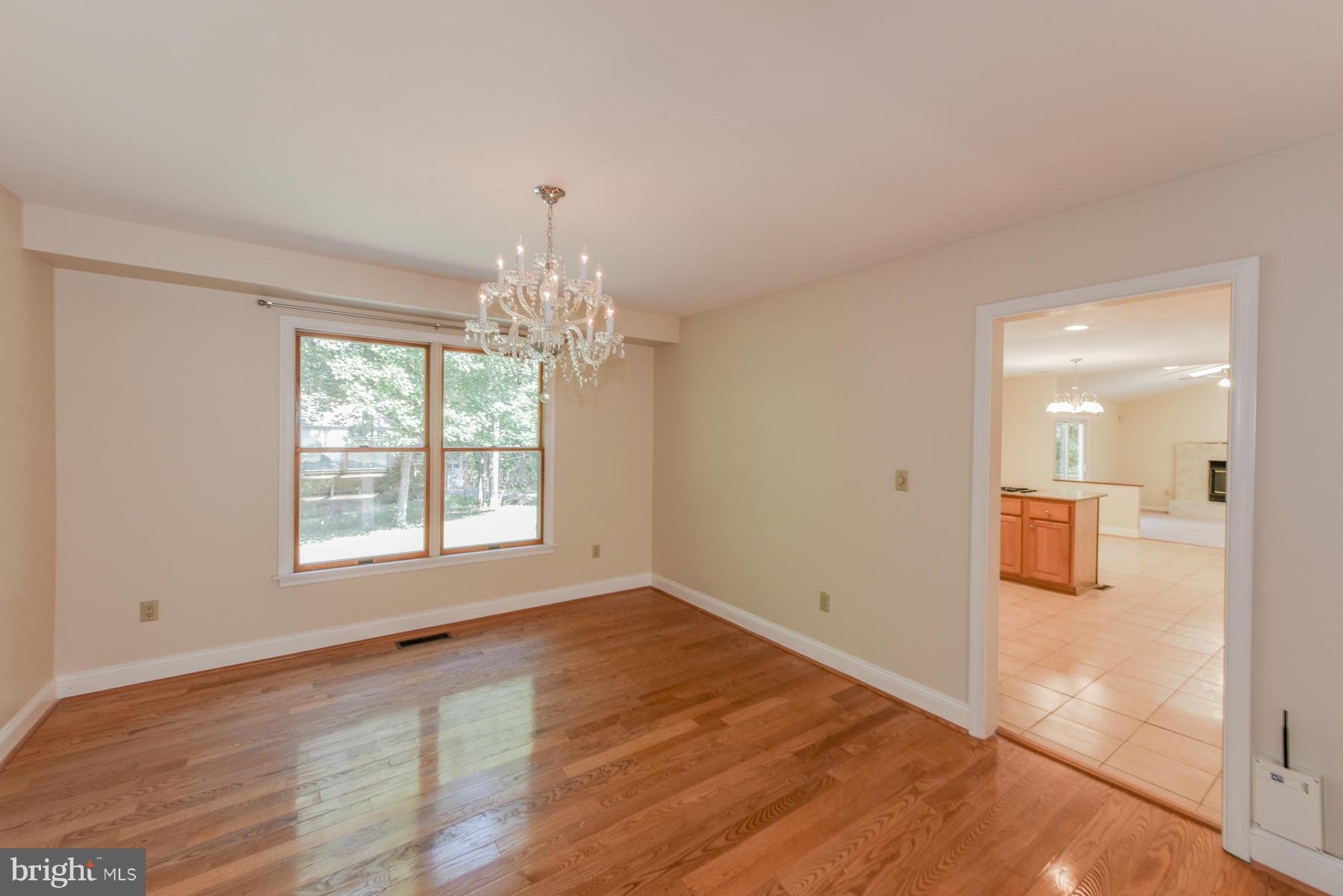 10541 Patuxent Ridge Way Laurel, MD 20723 - Photo 5 of 28 a view of an empty room with wooden floor and a window