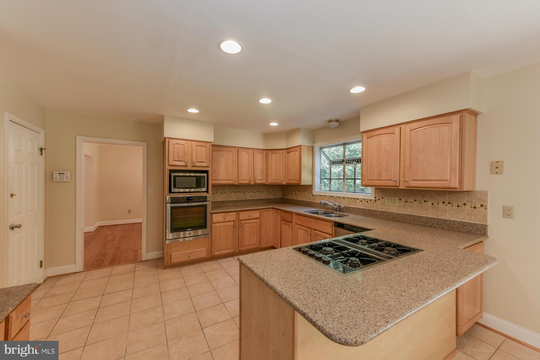 10541 Patuxent Ridge Way Laurel, MD 20723 - Photo 9 of 28 a kitchen with stainless steel appliances granite countertop a stove a sink and a refrigerator