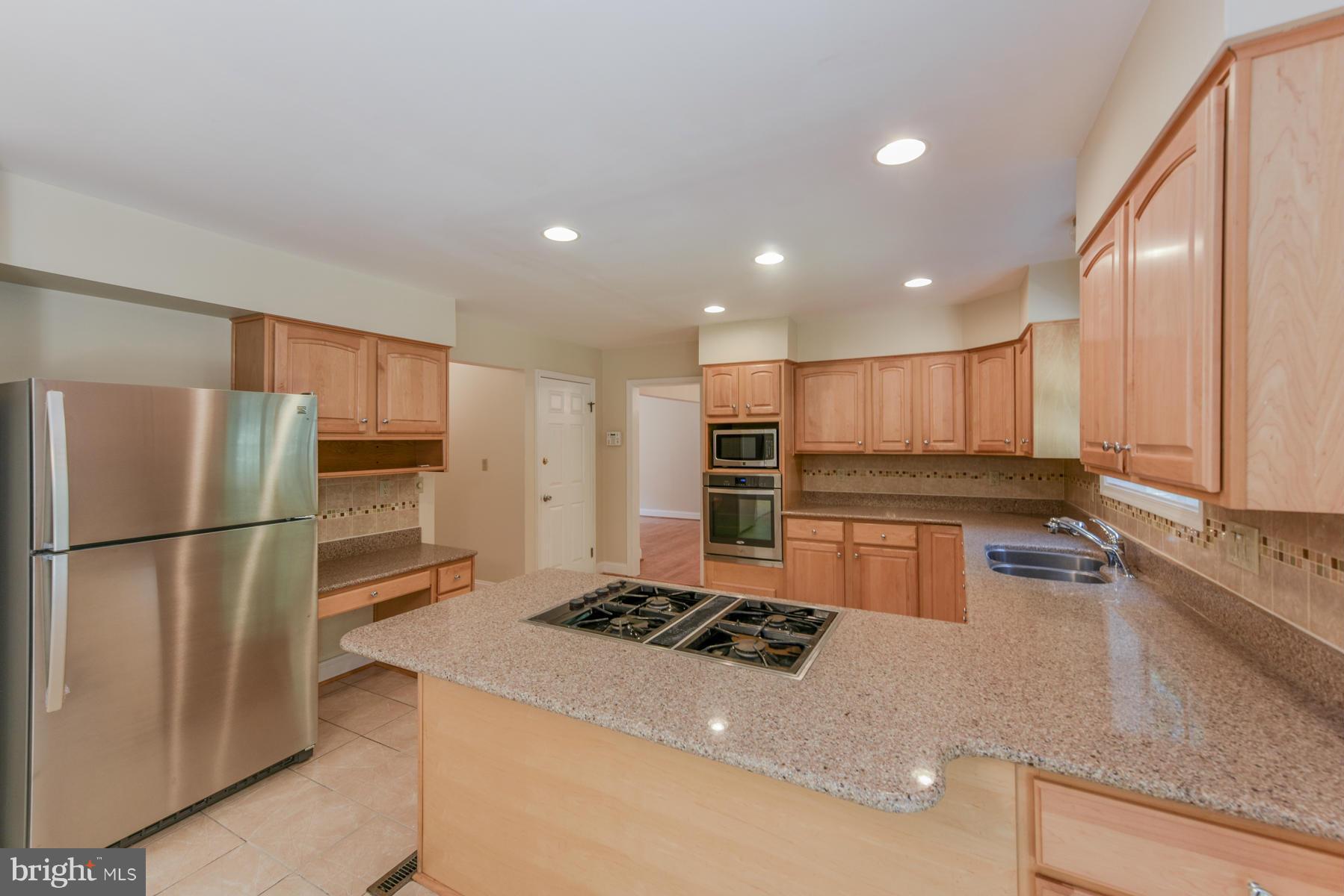 10541 Patuxent Ridge Way Laurel, MD 20723 - Photo 10 of 28 a kitchen with stainless steel appliances granite countertop a refrigerator sink and stove