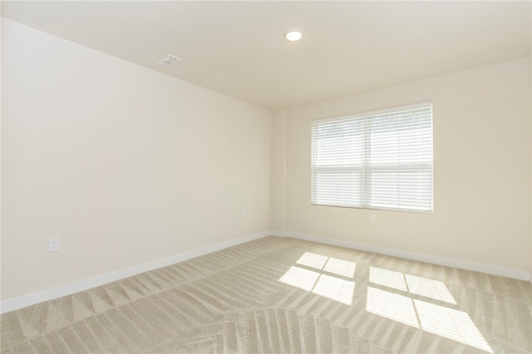 233 Scenic Road Anderson, SC 29621 - Photo 26 of 50 A well-lit, open room with natural illumination and a neatly carpeted floor.