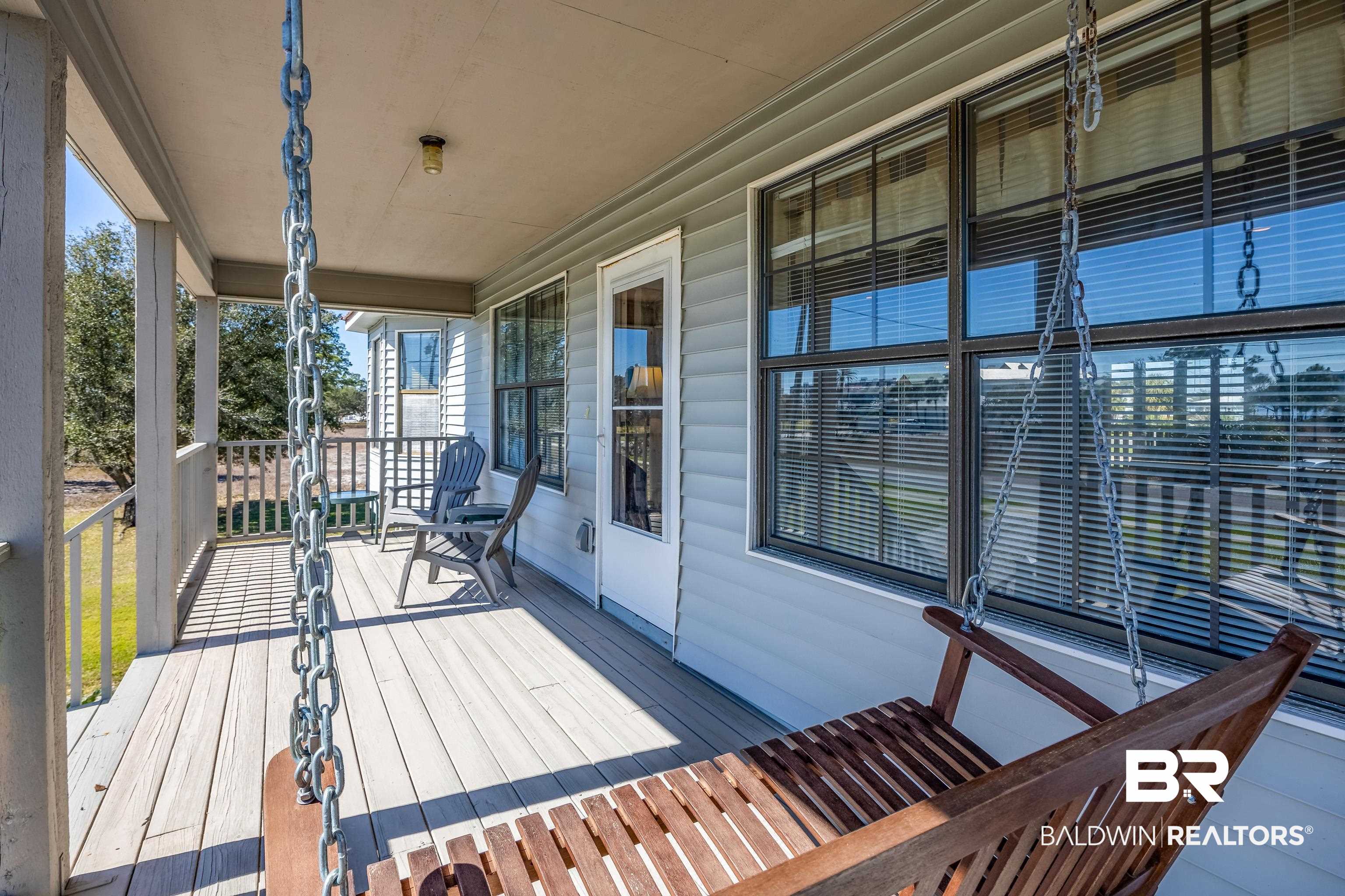 27321 Marina Road Orange Beach, AL 36561 - Photo 9 of 55 Wooden terrace featuring a porch