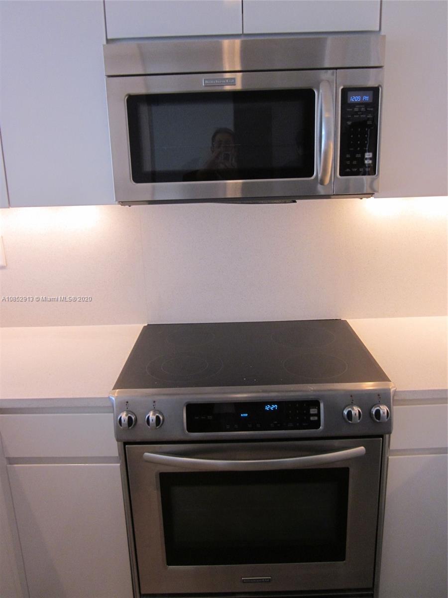 200 23rd Street, Unit 203 Miami Beach, FL 33139 - Photo 15 of 79 a stove top oven sitting inside of a kitchen