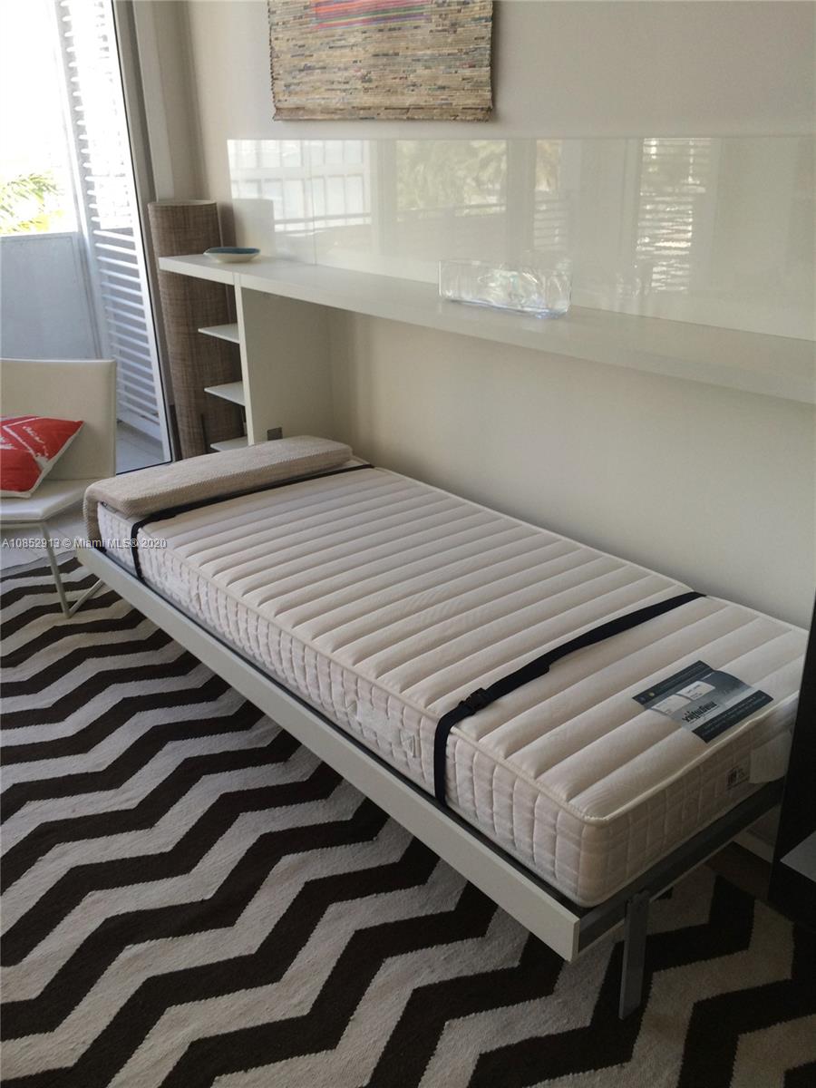 200 23rd Street, Unit 203 Miami Beach, FL 33139 - Photo 18 of 79 a bedroom with two beds and a window
