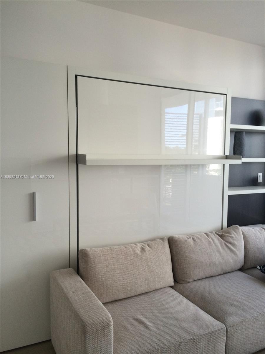200 23rd Street, Unit 203 Miami Beach, FL 33139 - Photo 20 of 79 a living room with a couch and a ceiling fan