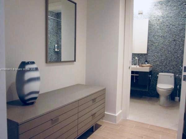 200 23rd Street, Unit 203 Miami Beach, FL 33139 - Photo 22 of 79 a bathroom with a toilet a sink and mirror