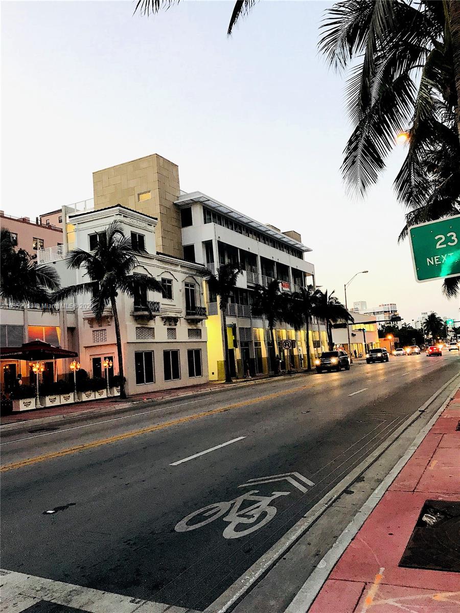 200 23rd Street, Unit 203 Miami Beach, FL 33139 - Photo 62 of 79 a city street with tall buildings and a cars parked on the side of road