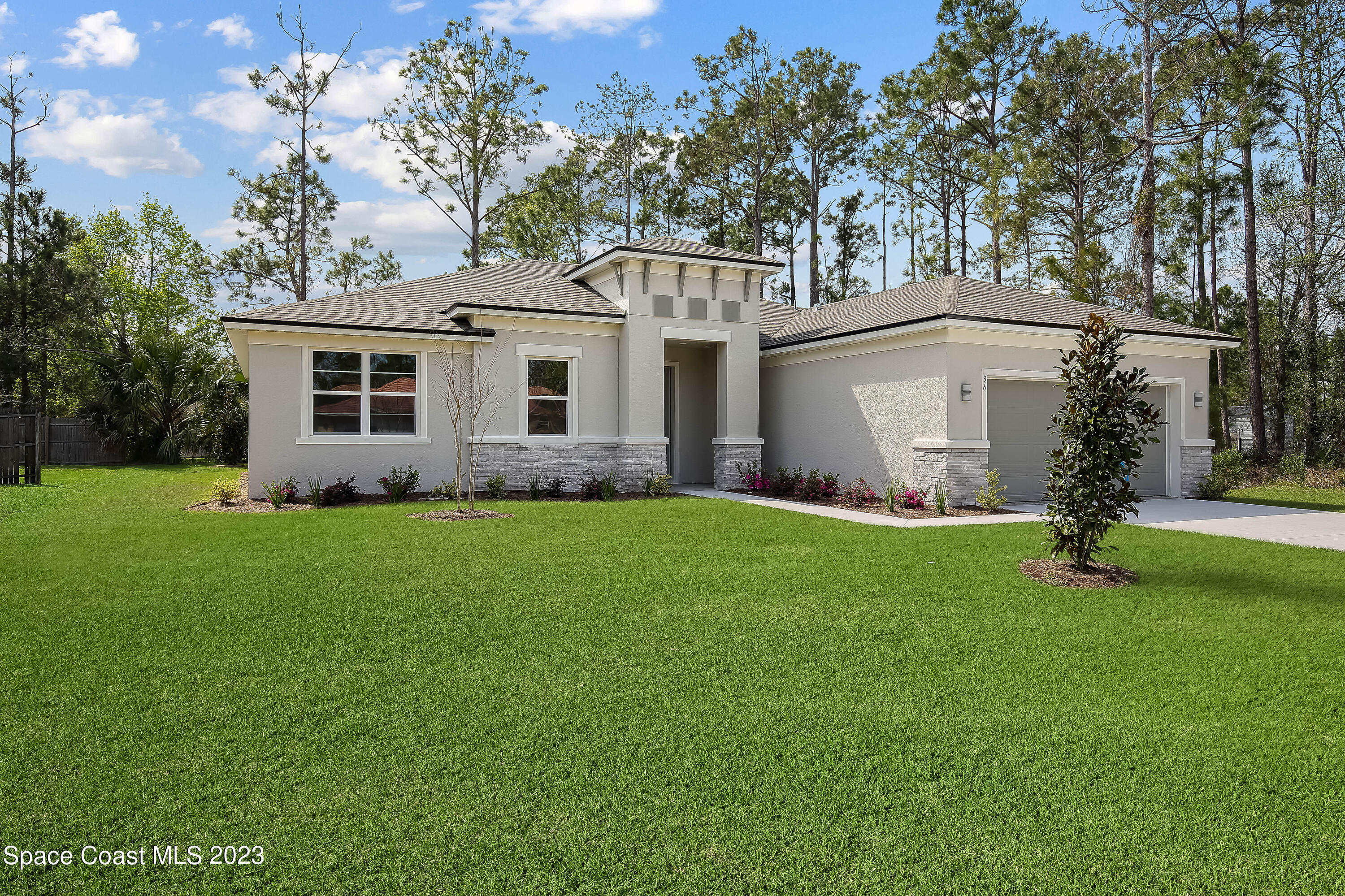 875 Clifton Road Southeast Palm Bay, FL 32909 - Photo 2 of 19 a front view of house with yard and green space