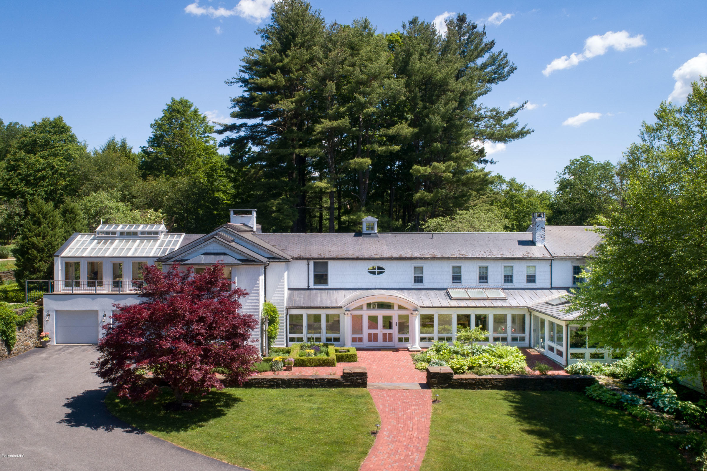 119 Under Mountain Road Lenox, MA 01240 - Photo 2 of 46 a front view of a residential apartment building with a yard and swimming pool