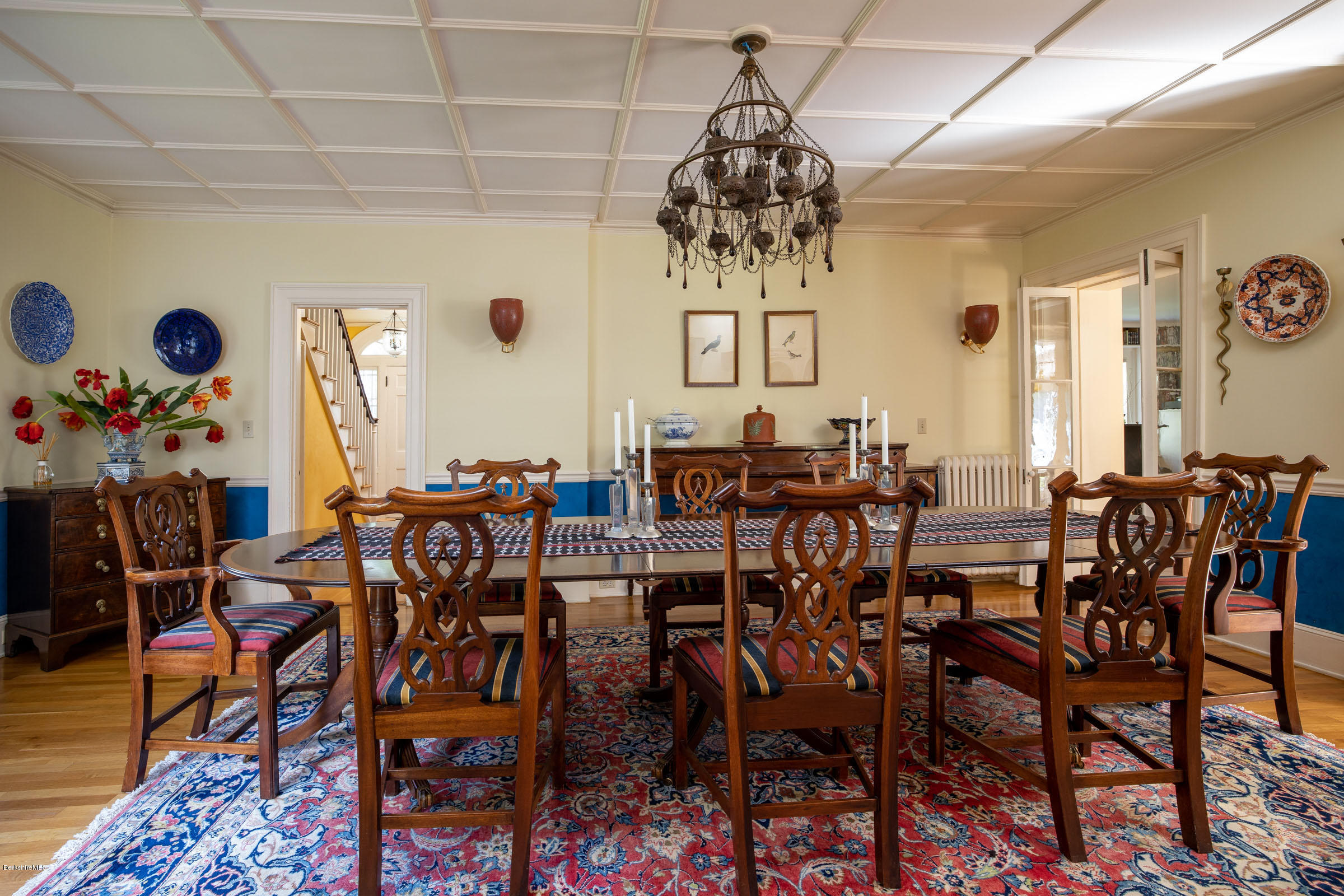 119 Under Mountain Road Lenox, MA 01240 - Photo 14 of 46 a view of a dining room with furniture a chandelier and wooden floor