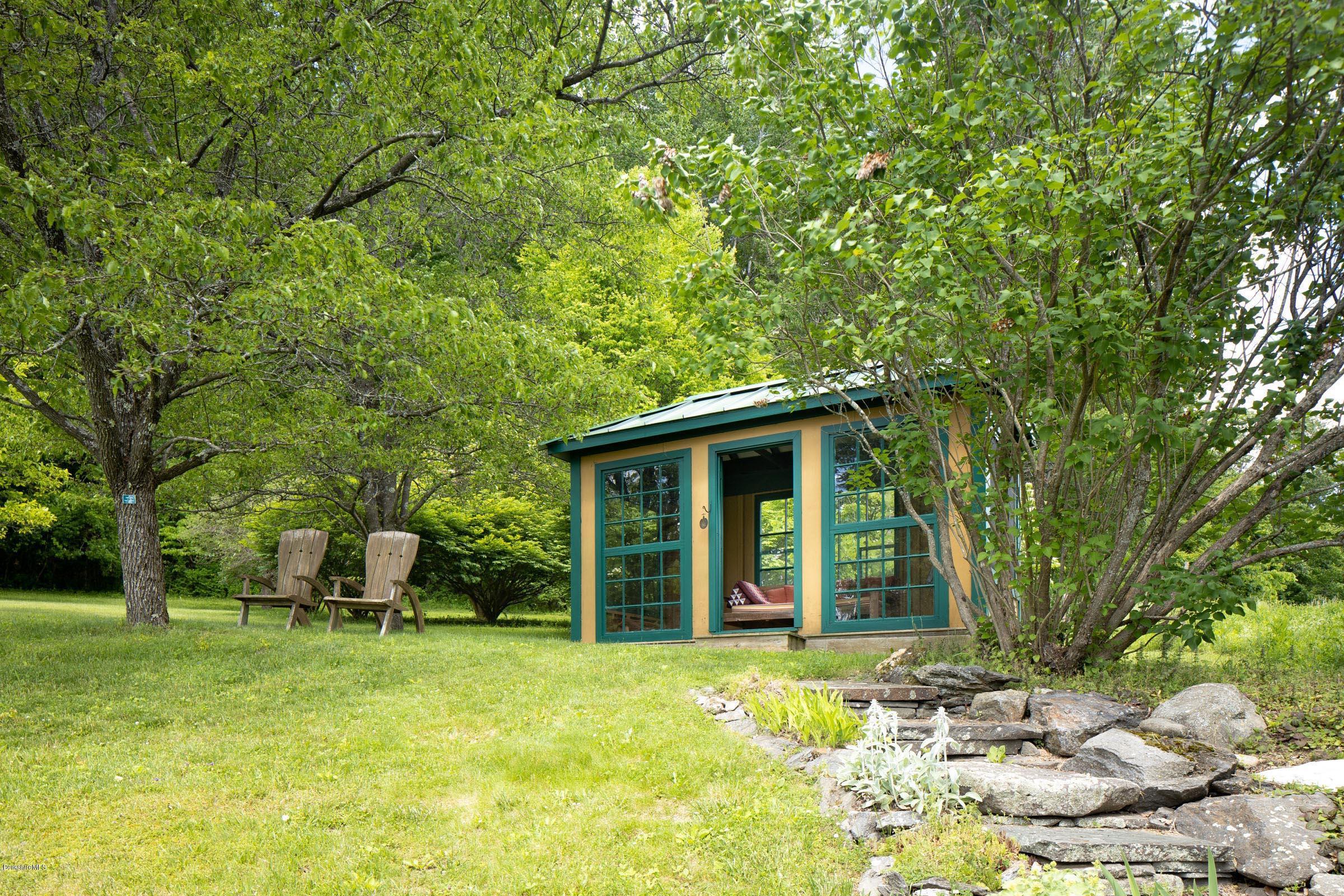 119 Under Mountain Road Lenox, MA 01240 - Photo 28 of 46 a view of a chair and table in backyard of the house