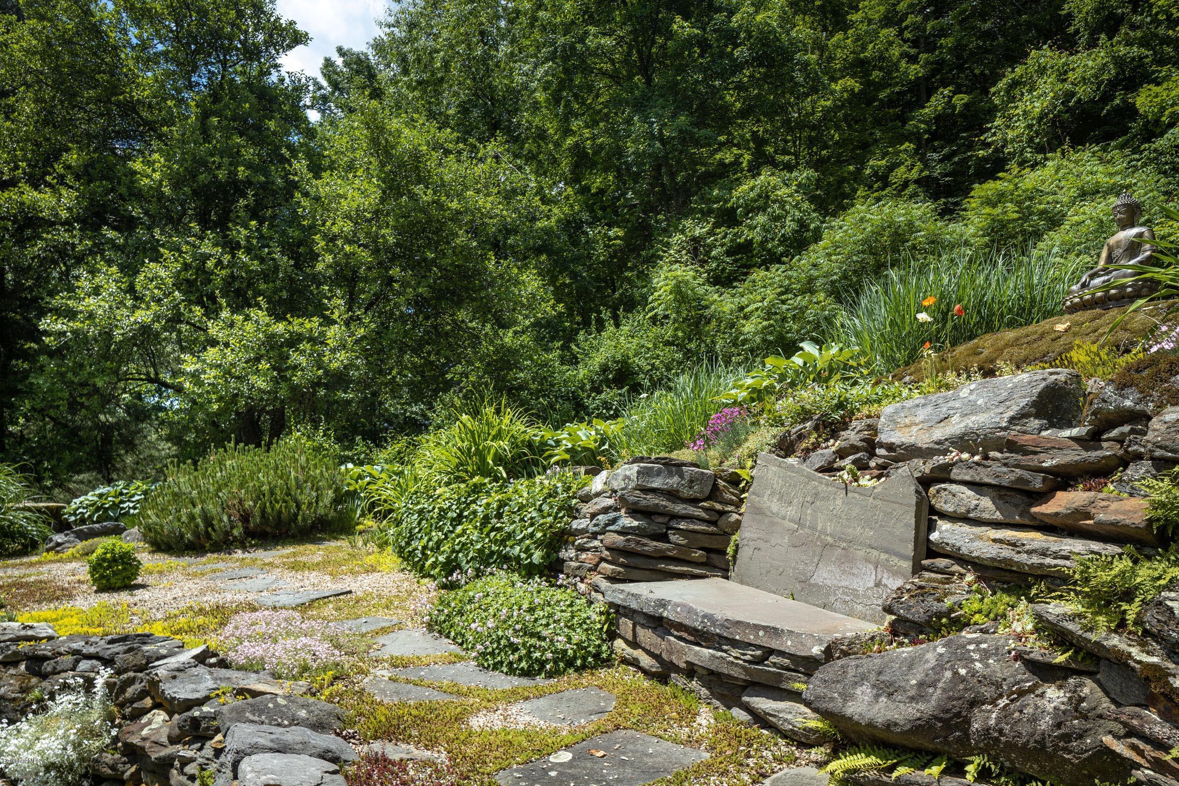 119 Under Mountain Road Lenox, MA 01240 - Photo 43 of 46 a view of a yard with plants and large trees
