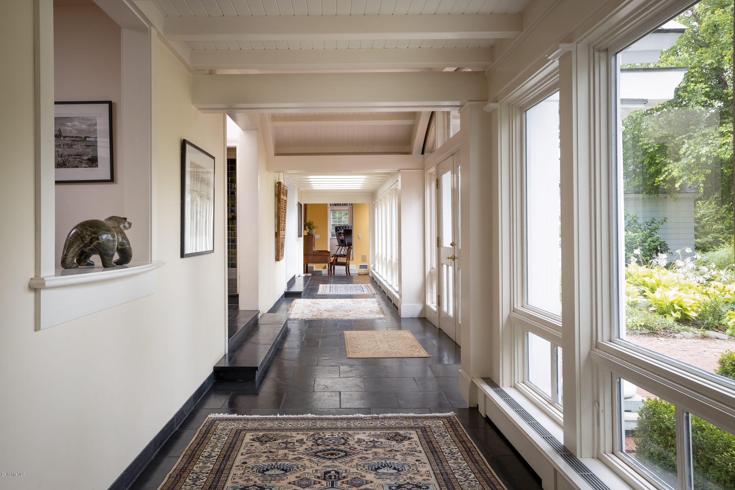 119 Under Mountain Road Lenox, MA 01240 - Photo 7 of 46 a hallway with wooden floor and windows