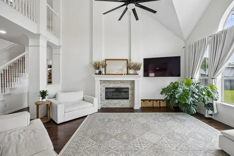 a living room with furniture and a fireplace