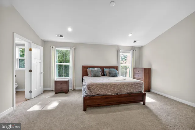 a spacious bedroom with a bed and a window