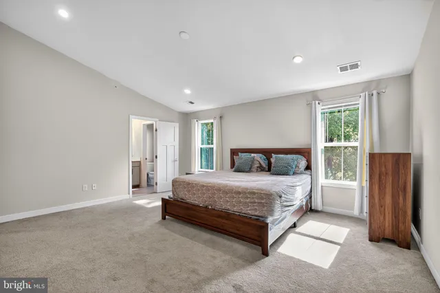 a spacious bedroom with a bed and a window